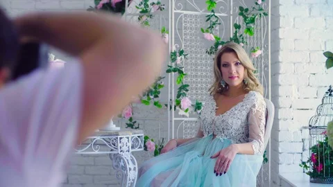 Pretty model in peignoir posing against white wall Stock Footage 88642446