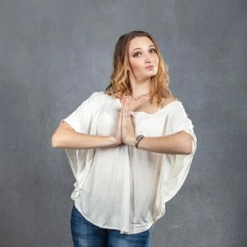 Pretty model with praying hands Stock Photos
