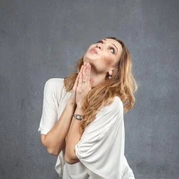 Pretty model with praying hands Foto stock