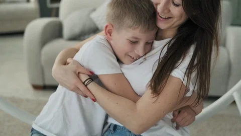 Pretty mom and son hugging at bed with pillows. Happy motherhood concept Video stock 107067726