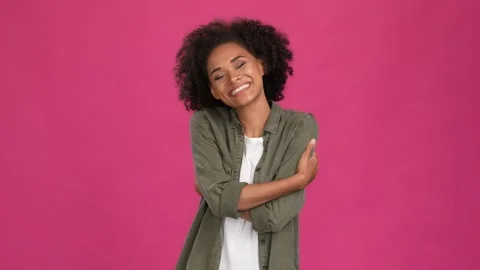 Pretty nice lady cuddle herself isolated fuschia color backround Stock Footage 166305295