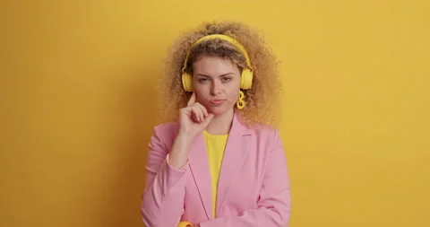 Pretty pensive curly haired young woman considers something thinks deeply about Stock-Footage 155251724