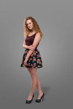 Pretty plus size young redhead and curly-haired girl wearing short skirt with Stock Photos
