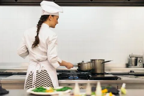 Pretty professional chef cooking. Stock Photos