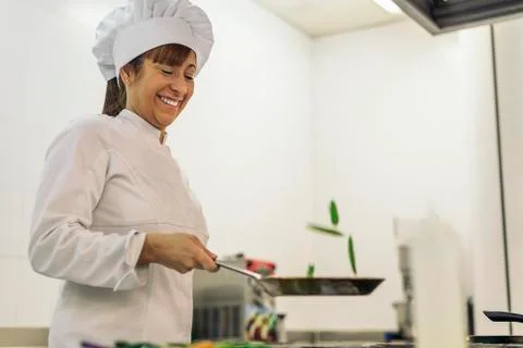Pretty professional chef cooking. Stock Photos