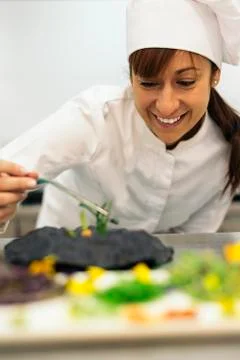 Pretty professional chef cooking. Stock Photos