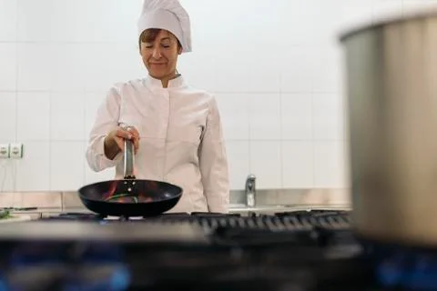 Pretty professional chef cooking. Stock Photos
