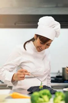 Pretty professional chef cooking. Stock Photos