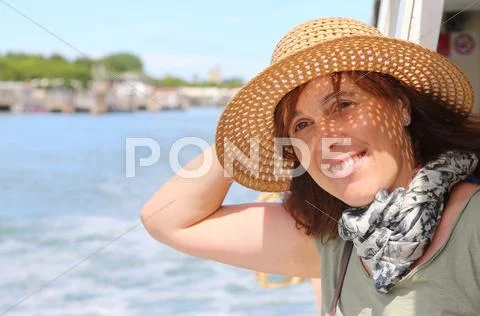Pretty real forty year old woman with straw hat Stock Photos