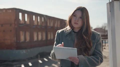 Pretty rooftop journaling by writer, focused pen strokes on paper, notetaking Stock Footage 337650304