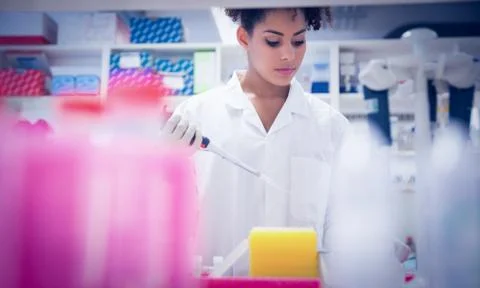 Pretty science student using pipette 写真素材