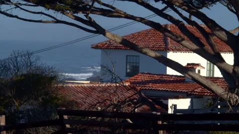 Pretty Seaside House With Waves Rolling in the Backdrop Stock Footage 154384080