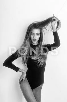 Pretty sexy girl with long hair in sexi black bodysuit Stock Photos