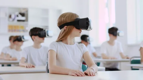 Pretty smart pupils wearing VR headsets studying with future technologies during Stock-Footage 111542397