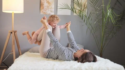 Pretty smiling cheerful young brown haired woman with her little baby kid i.. 動画素材 252087487