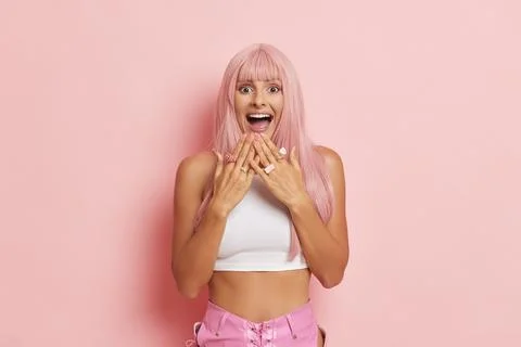 Pretty smiling female model posing on pink isolated background, close-up of girl Foto stock