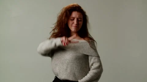 A pretty smiling lady is dancing joyfully with energetic fervor. A girl in Stock Footage 253036369