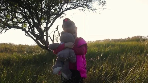 Pretty smiling little girl holding teddy bear. Little girl with teddy bear on na Stock Footage