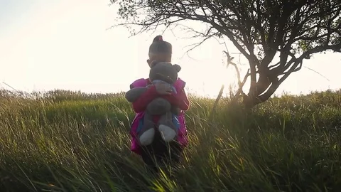 Pretty smiling little girl holding teddy bear. Little girl with teddy bear on na Stock Footage
