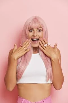 Pretty smiling model posing on pink isolated background, close-up of girl with Stock-Fotos