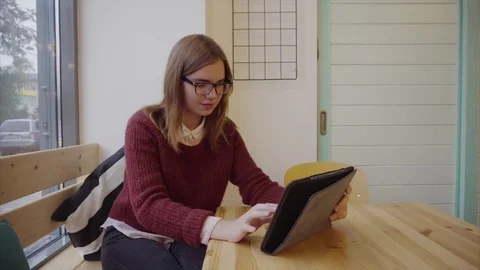 Pretty student girl using tablet phone in cafe Stock Footage 70685395
