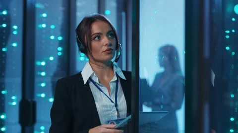 Pretty support service engineer inspecting rack server cabinet in digital room Stock Footage 120798134