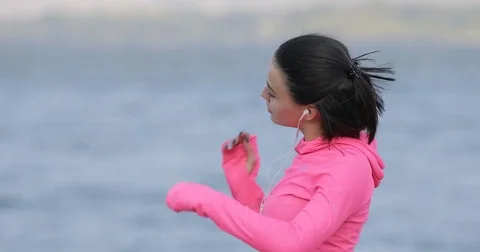 Pretty vigorous sportswoman in pink sportswear warming up before workout Stock Footage