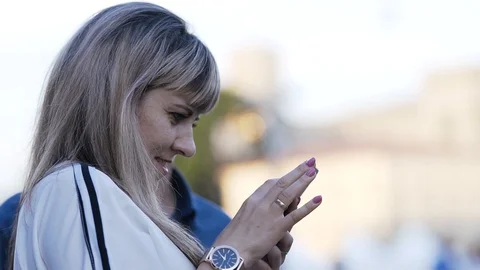 A pretty white-haired girl is browsing social networks on her phone. Stock Footage 126568756