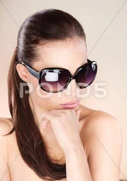 Pretty woman with big sun glasses Stock Photos
