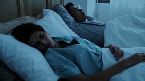 The pretty woman cannot sleep because of husband snoring Stock Footage 86719882