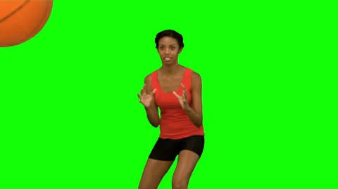 Pretty woman catching and throwing a basketball on green screen Stock Footage