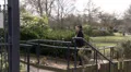 Pretty woman chatting on phone as she walks through the park HD Footage