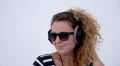 Pretty Woman Dancing with Headphones and in Sunglasses. HD Footage