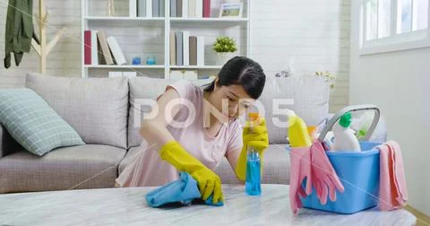 Pretty woman doing her house chores at home Stock Photos