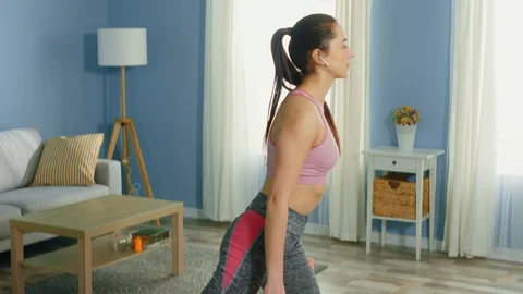 Pretty Woman Is Doing Split Squats at Home Stock Footage 128428007