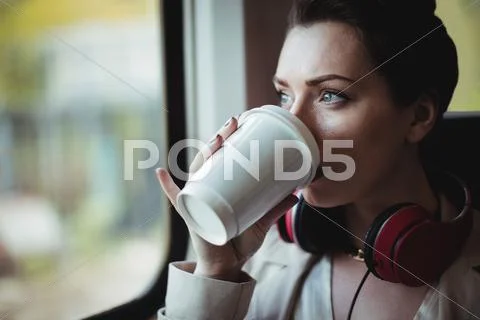 Pretty Woman Drinking Coffee By Window In Train