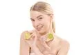 The pretty woman holding a lime on the white background Photo
