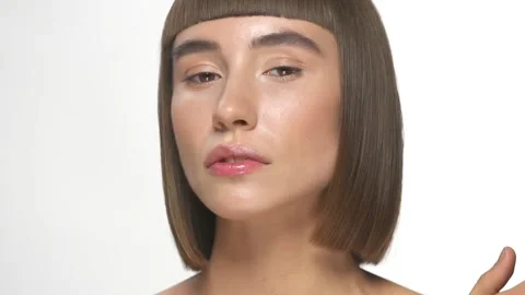 Pretty woman with light make-up posing on white Stock Footage 142811569
