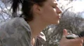 Pretty woman listening to music in the park HD Footage