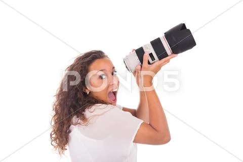 Pretty woman is a professional photographer with camera lens Stock Photos