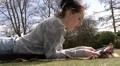 Pretty woman reading a magazine in the park HD Footage