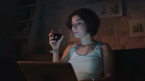 Pretty woman is reading a message on the computer while sitting at her home. Stock Footage 140871713
