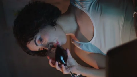 Pretty woman is reading a message on the computer while sitting at her home. Stock Footage 141119209