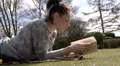 Pretty woman relaxing with a book outside HD Footage