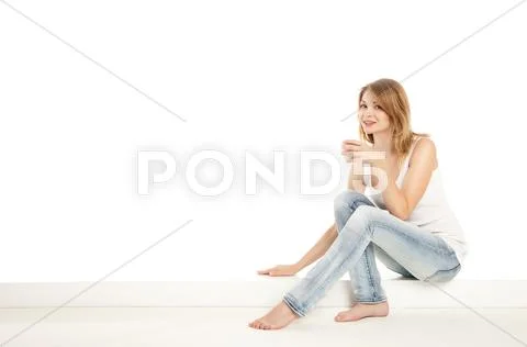Pretty woman relaxing at home and drink a coffee Stock Photos