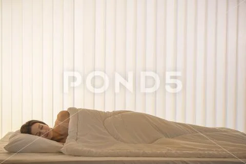 The pretty woman sleeping in the bed Stock Photos