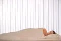 The pretty woman sleeping in the bed with a white linens Photo