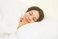 The pretty woman sleeping in the white linens Photo