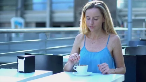 Pretty woman smiling, drinking coffee and relaxing in cafe, coffee shop Stock Footage 80388654