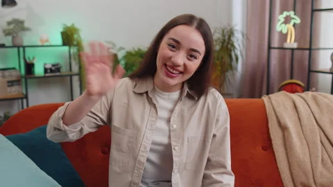 Pretty woman smiling friendly at camera, waving hands gesturing hello, hi Stock Footage 236301656